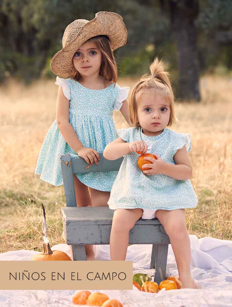 Sesión de fotos en el campo en Madrid de niños jugando en picnic al aire libre.